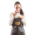 Beaitiful woman in a leather apron and white shirt holds a white cup with coffee or tea