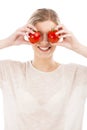 Beaitiful woman with tomatos in front of the face Royalty Free Stock Photo