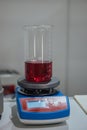 Beaker with chemical solution on laboratory scales