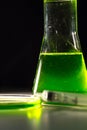 Beaker and retort with green and blue with chemical reagent. Chemical experiment with Laboratory glass Royalty Free Stock Photo