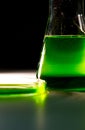 Beaker and retort with green and blue with chemical reagent. Chemical experiment with Laboratory glass Royalty Free Stock Photo