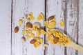 Beakfast cereals in wooden spoon. Healthy muesli with oat flakes, nuts and raisins isolated on white background Royalty Free Stock Photo