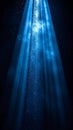 Beam of Blue Light with Sparkling Dust Particles on Dark Background Royalty Free Stock Photo