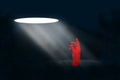 A beam of light falls on a red man in Depression. melancholy, pessimism, loneliness. Unhappy, sad man in a bad mood. Modern design