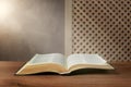 Beam of light over open Bible on wooden table Royalty Free Stock Photo