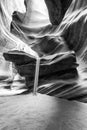 Beam of sand is flowing off the rocks in the interior of the narrow walls of the winding Antelope Canyon, Arizona