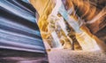 Beam of sand is flowing off the rocks in the interior of the narrow walls of the winding Antelope Canyon, Arizona