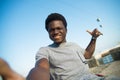 Beaming African American man having walk on summer day