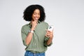 A beaming African-American woman engaging with her smartphone exudes confidence and happiness