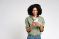 A beaming African-American woman enjoys a lighthearted moment with her smartphone