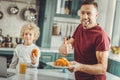 Beaming bearded man feeling happy spending nice family morning