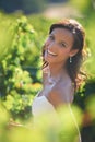 Beaming bride. A gorgeous bride smiling while standing in a vineyard.