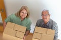 Beaming elderly couple moving into new house