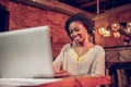 Attractive afro-american girl sitting with smile in front of computer