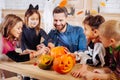 Beaming man inviting his children and nephews for Halloween party Royalty Free Stock Photo