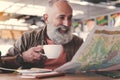 Beaming pensioner drinking cup of coffee