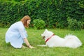 Beaming woman enjoying the process of training her dog Royalty Free Stock Photo