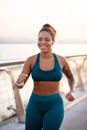 Beaming woman working on weight loss running fast