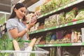 Beaming woman telling by mobile in store