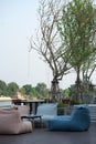 Bean bags seating and low timber for dining set with river background