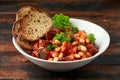 Bean and chorizo stew served in white bowl with parsley Royalty Free Stock Photo