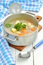 Bean soup in an old mess tin, ladle, spoon and towel Royalty Free Stock Photo