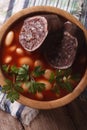Bean soup with sausage morcilla closeup. vertical top view