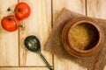 Bean soup in a traditional pot on a wooden background. View from above. The concept of healthy and natural food. Royalty Free Stock Photo