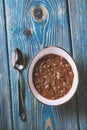 Bean soup in white bowl and spoon on wooden table. Royalty Free Stock Photo