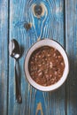 Bean soup in white bowl and spoon on wooden table. Royalty Free Stock Photo