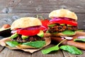 Bean and sweet potato veggie burgers over a wood background Royalty Free Stock Photo