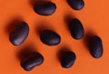 Black beans on orange background in daylight