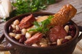 Beans with chicken legs and grilled sausages close up horizontal Royalty Free Stock Photo
