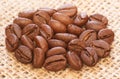 Beans of coffee macro on burlap fabric background Royalty Free Stock Photo