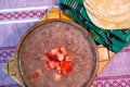 Beans cooked in a clay dish with tomato and tortillas, mexican poor dish Royalty Free Stock Photo