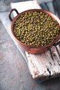 Beans in a copper bowl on a wooden stand diagonal Royalty Free Stock Photo