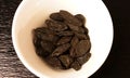 Tonka beans inside white bowl, shot from above. Royalty Free Stock Photo
