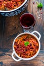 Beans with pork stewed in spicy tomato sauce with onion, paprika, beer, bell and pink pepper. Royalty Free Stock Photo