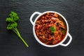 Beans with pork stewed in spicy tomato sauce with onion, paprika, beer, bell and pink pepper. Royalty Free Stock Photo