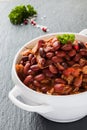 Beans with pork stewed in spicy tomato sauce with onion, paprika, beer, bell and pink pepper. Royalty Free Stock Photo