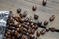 Beans poured out of the coffee bag. New packaging of coffee beans. Coffee beans on the table next to the package. Lots Royalty Free Stock Photo