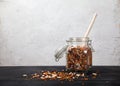 Beans, white and red, lentils green and red, peas in a glass jar on a black table on a white background. Sprinkled beans and Royalty Free Stock Photo