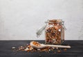 Beans, white and red, lentils green and red, peas in a glass jar on a black table on a white background. Sprinkled beans and Royalty Free Stock Photo