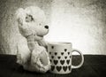 Bear with a cup with hearts on the background of sacking Royalty Free Stock Photo
