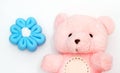 Bear cute pink bear with beautiful blue flowers isolated from white background.