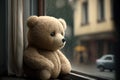 bear doll sitting on the window sill, watching the outside world Royalty Free Stock Photo