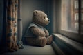 bear doll sitting on the window sill, watching the outside world Royalty Free Stock Photo