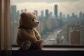 bear doll sitting on windowsill with view of city skyline