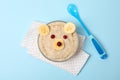 Bear face made of porridge and fruits on background, top view. Baby food Royalty Free Stock Photo