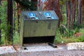 A bear proof garbage container along side a parking lot Royalty Free Stock Photo